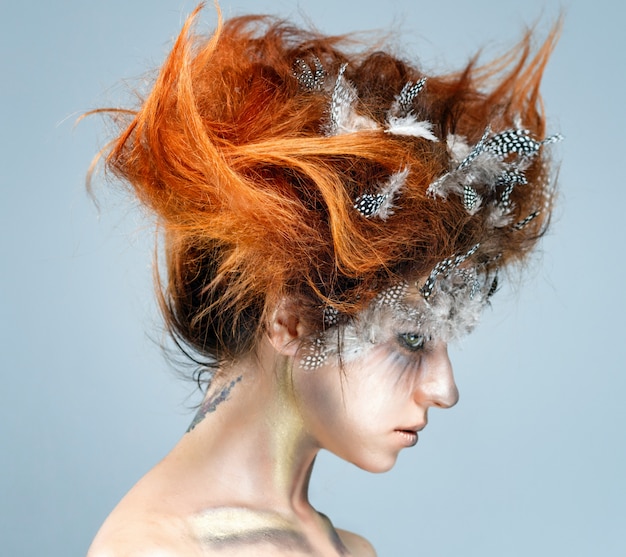 Young beautiful woman with complicated avant-garde hairstyle. 