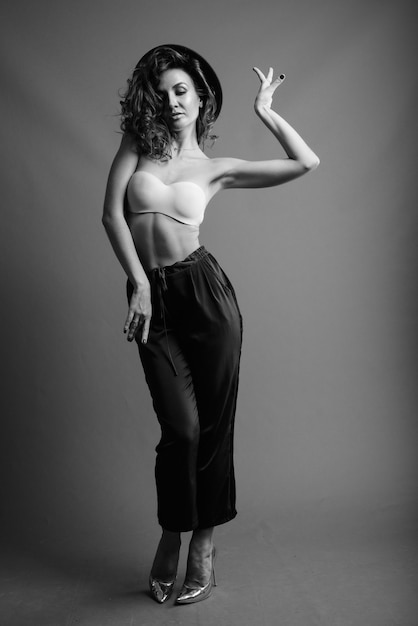 Young beautiful woman with curly hair posing in black and white