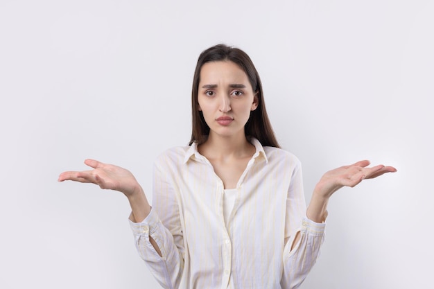 Young beautiful woman with facial expression of surprise standing over white background