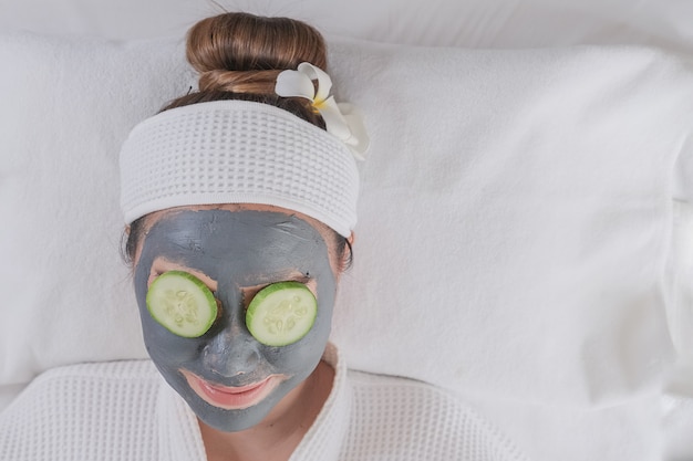 Young beautiful woman with facial mask