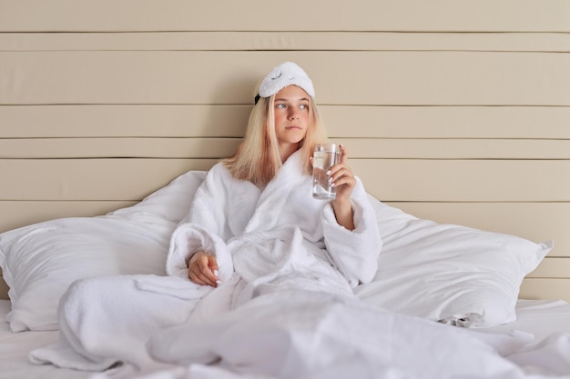 Young beautiful woman with glass of water