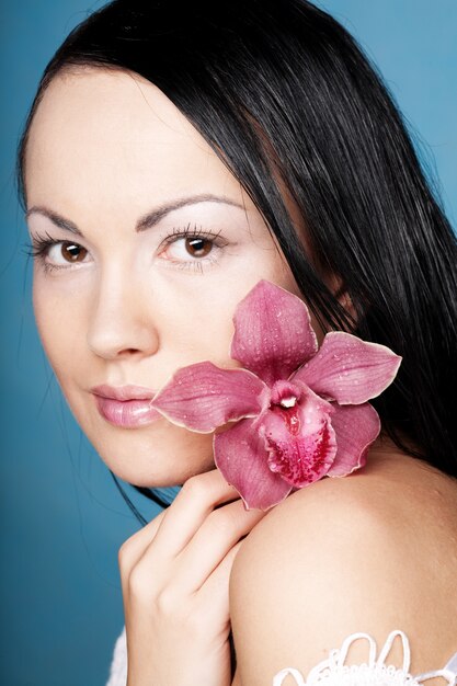 Young beautiful woman with pink flower