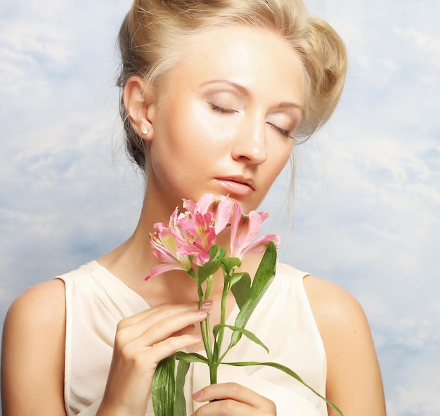 Young beautiful woman with pink flower