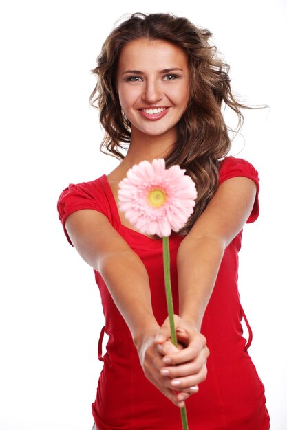 Young beautiful woman with pink fresh flower