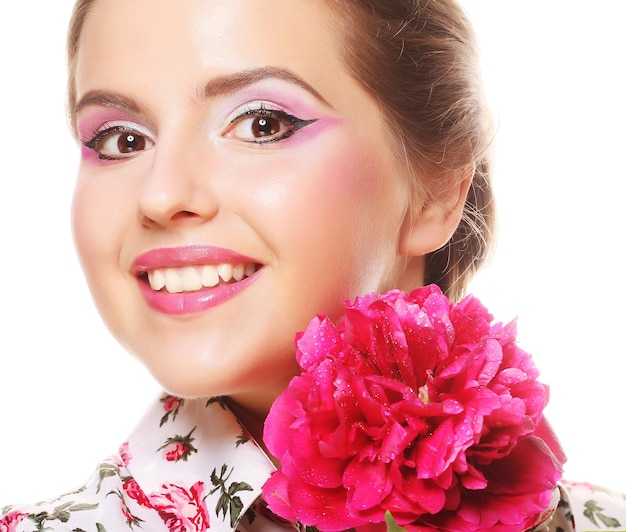 Young beautiful woman with pink peony