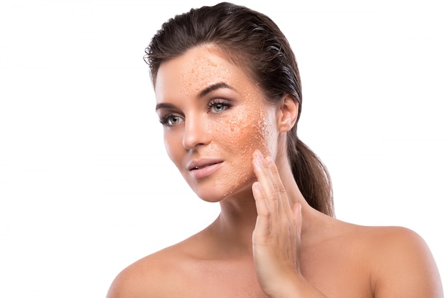 Young beautiful woman with sugar scrub on her face