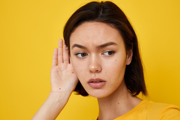 Young beautiful woman yellow tshirt summer style hand gesture isolated background