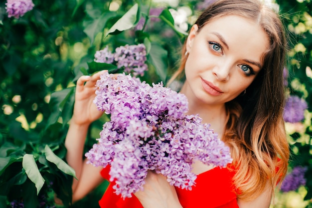 Young beautiful womanposing among the flowering tree