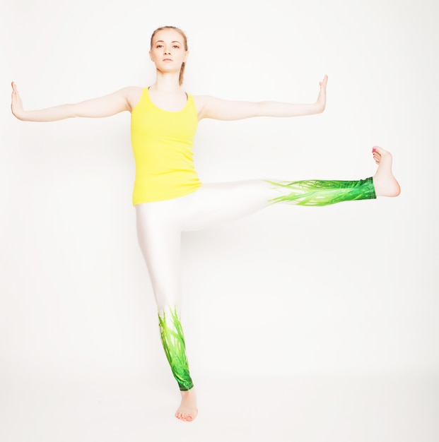 Young beautiful yoga posing  over white background