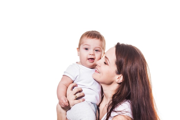 Young beauty mother holding her adorable baby on the white background