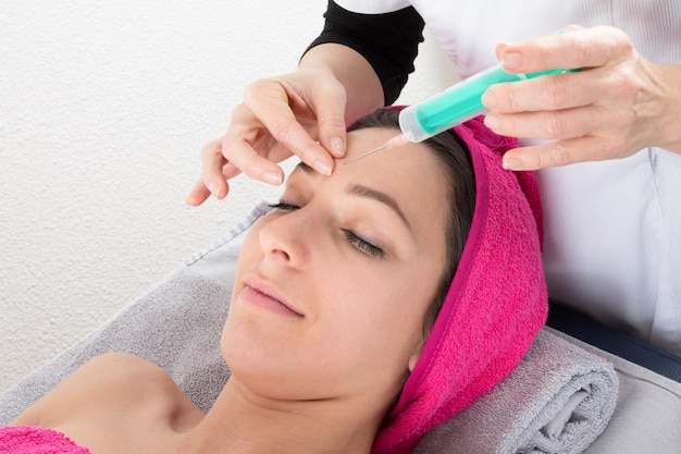 Young and a Beauty woman giving botox injections