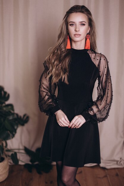 Young beauty woman portrait in black dress. 