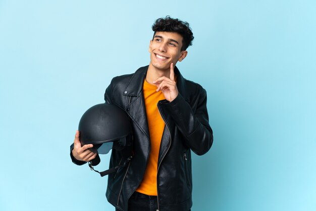 Young biker holding a motorcycle helmet