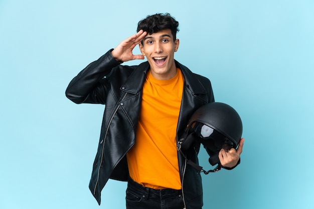 Young biker holding a motorcycle helmet