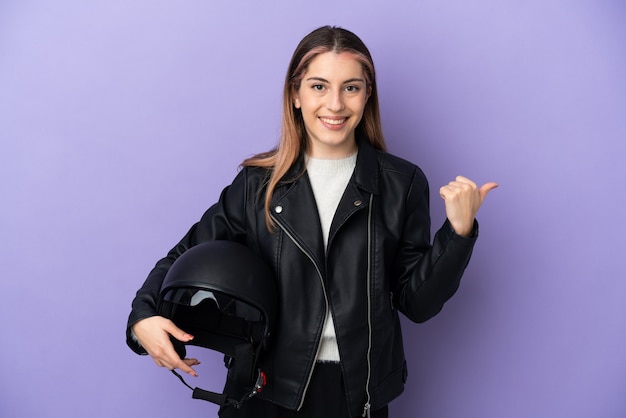 Young biker holding a motorcycle helmet