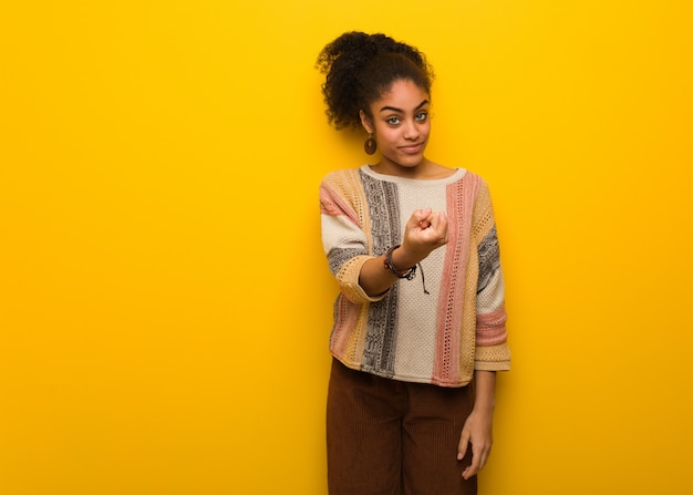 Young black african american woman with blue eyes inviting to come