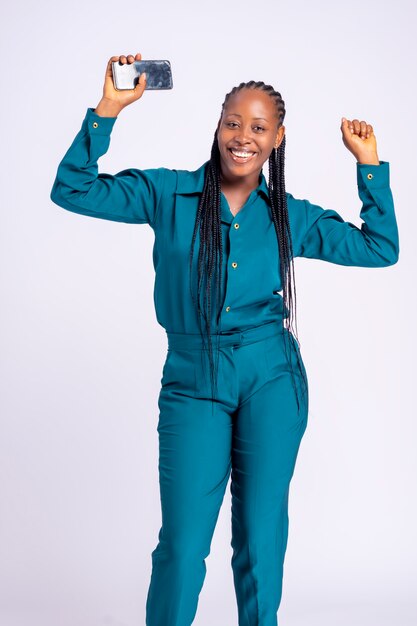 Young black african business woman laughing holding a mobile phone