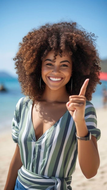 Young black American lady at the beach smiling on a sunny day looking into the camera