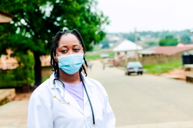 Young black beautiful female surgeon outside a street with medical stethoscope