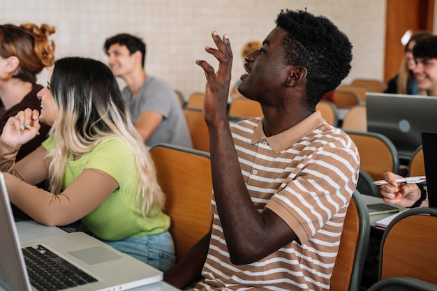 Young black boy raising his hand in class