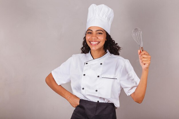 Young black brazilian woman cook masterchef holding fue preparing sweets