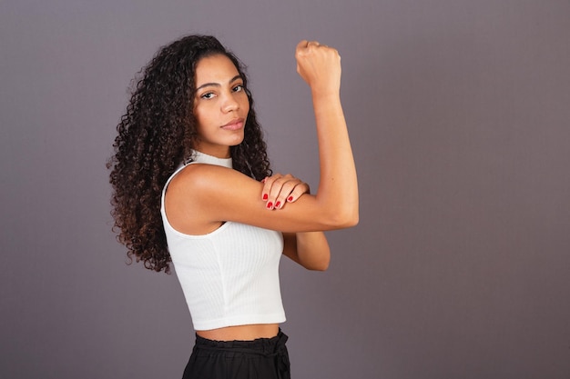 Young black Brazilian woman with raised and closed fist militancy feminism