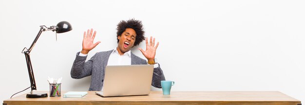 Young black businessman feeling stupefied and scared