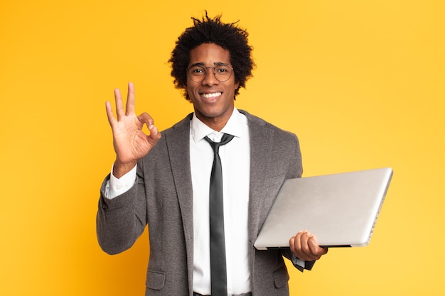 Young black businessman with a laptop