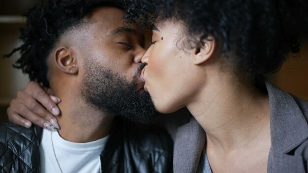 A young black couple kissing passionately