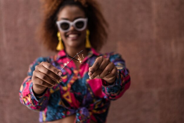 Young black female showing sparklers