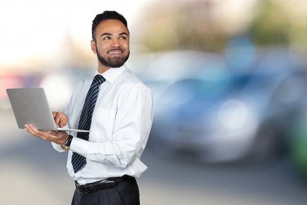 Young Black Male Holding Laptop Isolated portrait