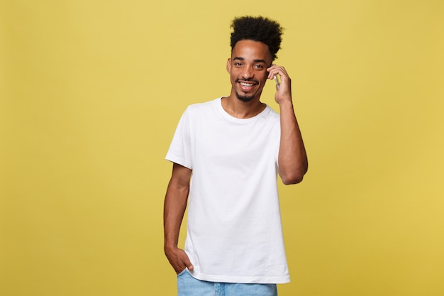 Young black man smiling and talking on mobile phone 