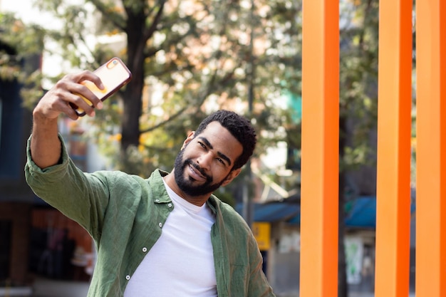 Young black man taking a selfie in the street