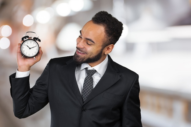 Young black man with alarm clock