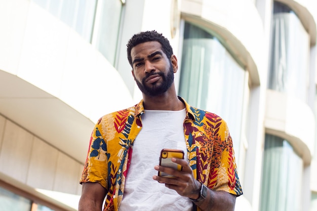 Young black man with a smartphone on the street