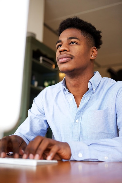 young black man working with computer at office