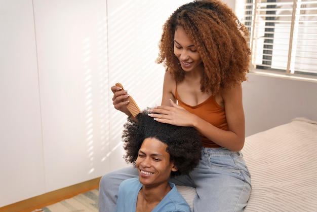 Young black people taking care of afro hair