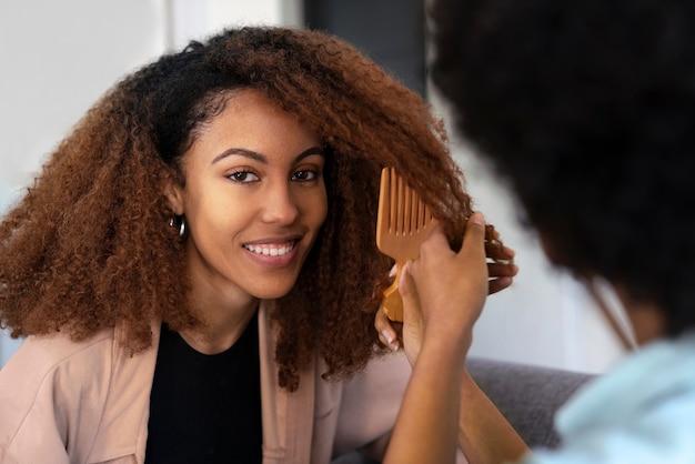 Photo young black person taking care of afro hair