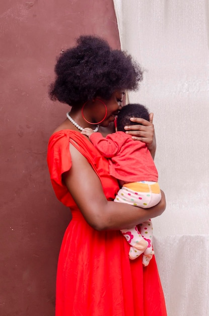 Young black woman carrying baby