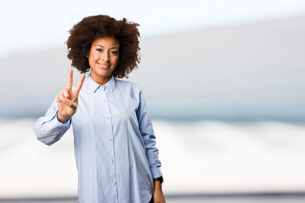 young black woman doing victory gesture