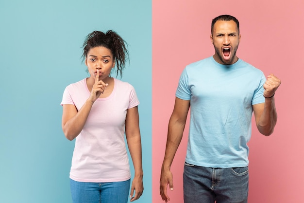 Foto giovane donna di colore che gesturing segno di silenzio tenendo il dito vicino alla bocca uomo urlando e stringendo il pugno alla macchina fotografica