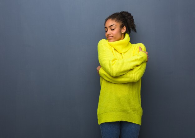 Young black woman giving a hug