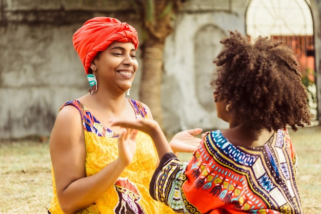 Young black woman playing with her daughter