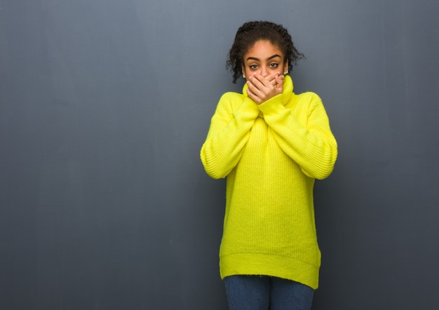 Young black woman surprised and shocked