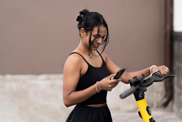 A young black woman taking a scooter for a rent in the city eco friendly vehicle