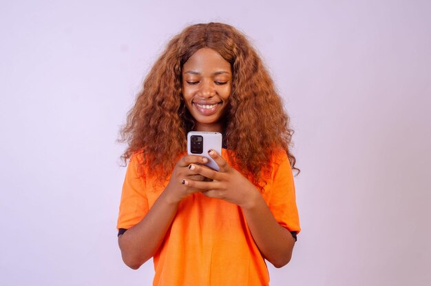 Young black woman using her phone and smiling