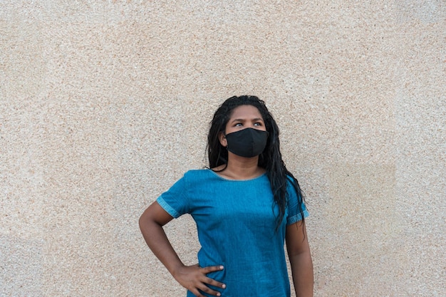 Young black woman with black hair and protective mask