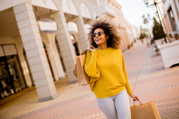 Young black woman with curly hair in shopping