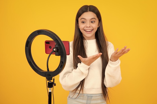 Young blogger recording video for blog Teen girl speaking in front of camera for vlog Teenager