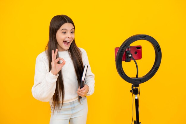 Young blogger recording video for blog teen girl speaking in front of camera for vlog teenager